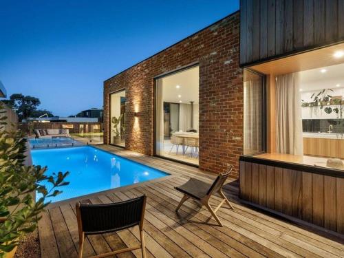 a house with a swimming pool on a wooden deck at LUXE Poolside living, in the heart of Flinders in Flinders