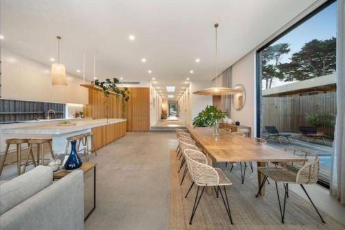 a kitchen and dining room with a table and chairs at LUXE Poolside living, in the heart of Flinders in Flinders