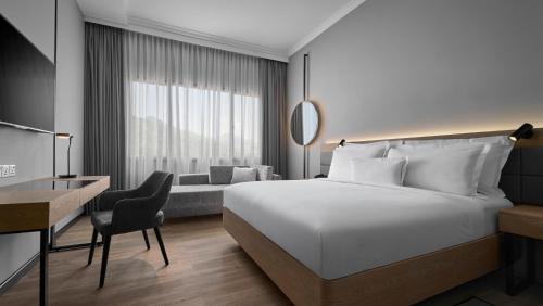 a hotel room with a bed and a desk at AC Hotel by Marriott Penang in Bayan Lepas