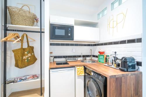a small kitchen with a washer and dryer in it at Studio Terrasse Privée 5 min to Eiffel Tower in Paris