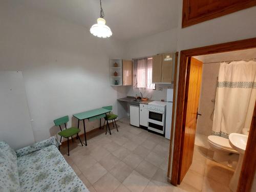 a small kitchen with a table and a table at Casa Rural Nueva Araceli in Oliete