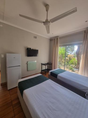 a hotel room with two beds and a window at Bonnie Highlands in Ladysmith