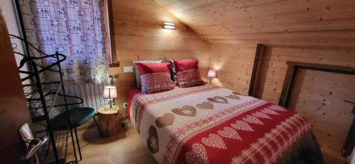 1 dormitorio con 1 cama en una cabaña de madera en Appartement style montagne avec SPA, en Égat