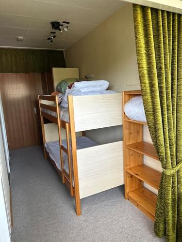 a room with two bunk beds and a curtain at Ruhige Ferienwohnung in Schönwald in Schönwald