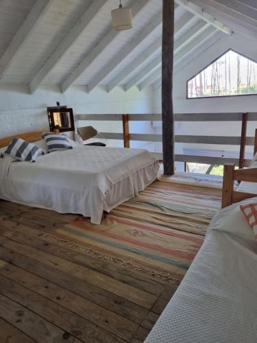 a bedroom with two beds and a large window at Casa bosque y mar in Ocean Park