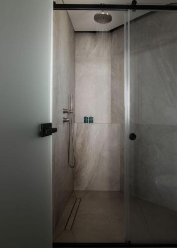 a bathroom with a shower with a glass door at Eran Luxury Villa with Private Pool & Sea Views, by ZanteWize in Akrotiri