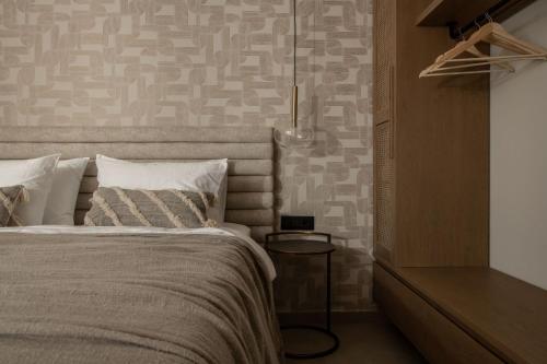 a bedroom with a bed and a wall with a pattern at Eran Luxury Villa with Private Pool & Sea Views, by ZanteWize in Akrotiri