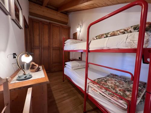 a room with two bunk beds and a desk at Residenza Arcadia in Giustino