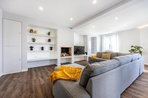a living room with a couch and a fireplace at Angra Charming Suites by Seewest in Angra do Heroísmo