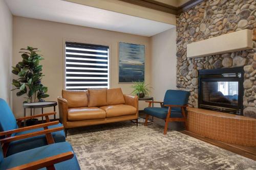 a living room with a couch and a fireplace at Days Inn by Wyndham Medicine Hat in Medicine Hat