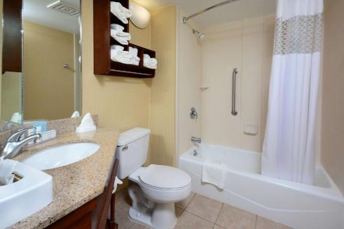 a bathroom with a toilet and a sink and a tub at Hampton Inn Raleigh/Town of Wake Forest in Wake Forest