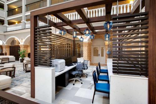 an office with a desk with a computer and chairs at Embassy Suites by Hilton Orlando International Drive Convention Center in Orlando