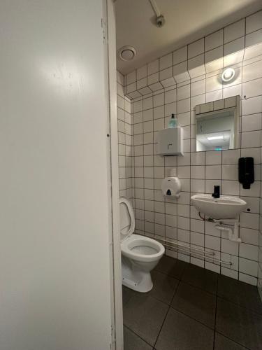 a bathroom with a toilet and a sink at Hostel by Bromma in Stockholm