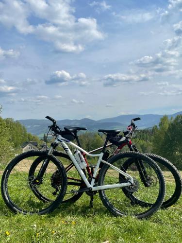 two bikes parked in the grass on a hill at Chata Vápenná in Jeseník