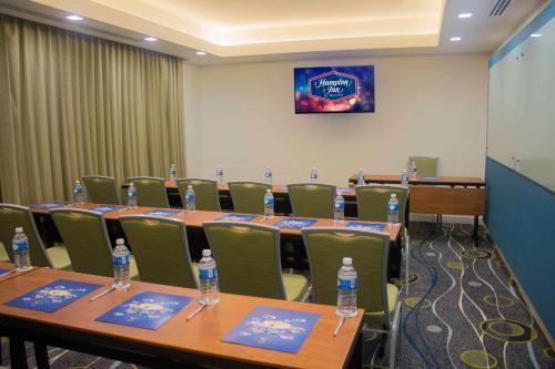 a conference room with tables and chairs with bottles of water at Hampton Inn by Hilton Merida in Mérida