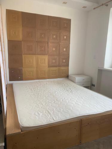 a bed in a room with a wooden frame at Apartmány Blatec in Blatec