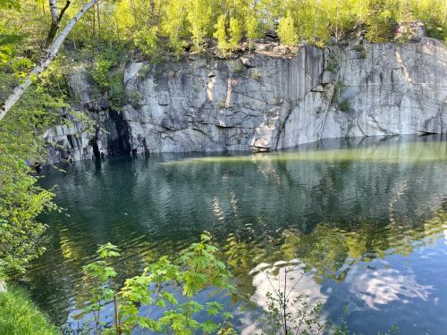 a pool of water next to a rocky cliff at Chata Vápenná in Jeseník