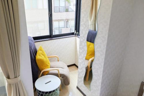a room with two chairs and a table and a window at 錦系町天空樹景觀飯店 Skytree View Kinshicho in Tokyo