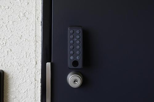 a black door with a remote control on it at 錦系町天空樹景觀飯店 Skytree View Kinshicho in Tokyo