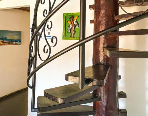 a set of stairs in a museum with a painting on the wall at Hotel Malibu in Porto Seguro