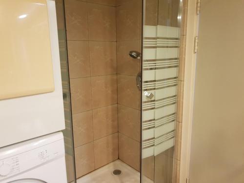 a shower with a glass door in a bathroom at beach Apartments in Haifa