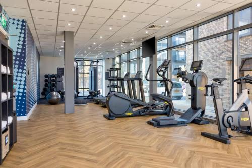 a gym with treadmills and cardio equipment in a building at Hampton by Hilton Ashford International in Ashford