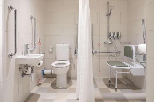 a bathroom with a toilet and a sink at Hampton by Hilton Ashford International in Ashford