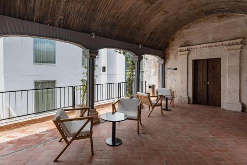 a group of chairs and tables on a balcony at Hampton by Hilton Arequipa in Arequipa