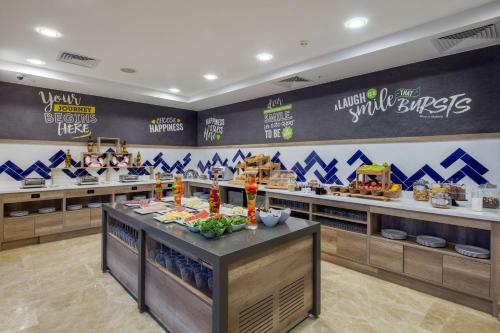 a fast food restaurant with a counter with food at Hampton by Hilton Canakkale Gelibolu in Gelibolu