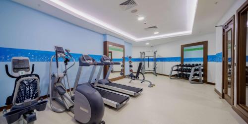 a gym with treadmills and ellipticals in a room at Hampton by Hilton Canakkale Gelibolu in Gelibolu