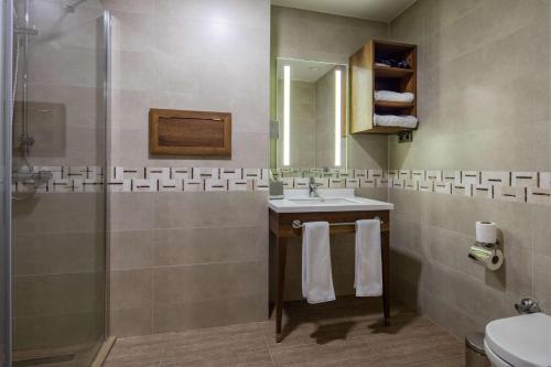 a bathroom with a sink and a shower at Hampton by Hilton Canakkale Gelibolu in Gelibolu