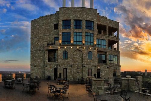 a building with tables and chairs in front of it at The Oread Lawrence, Tapestry Collection by Hilton in Lawrence
