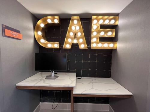 a desk with a sign that says exit at La Quinta Inn by Wyndham Columbia NE Fort Jackson in Columbia