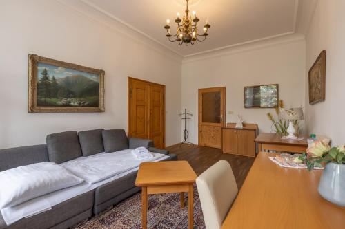 a living room with a couch and a table at Hotel Šipka in Štramberk