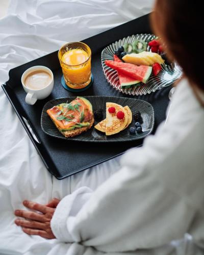 a tray of food on a bed with a plate of food at Molina Lario in Málaga