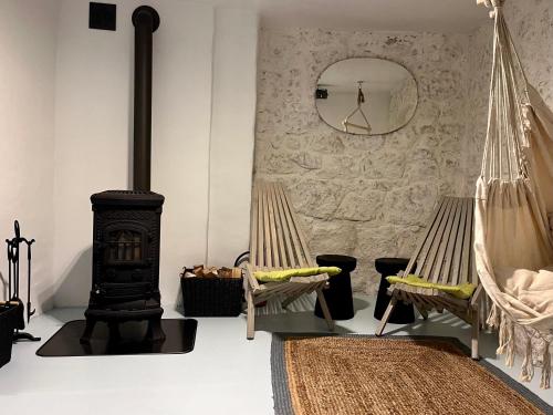 a room with two hammocks and a wood stove at Dom w murach in Lwówek Śląski
