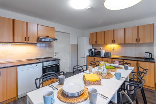 a kitchen with a table and chairs in it at The Bookhouse, 5-bedroom residence by Prague Castle in Prague