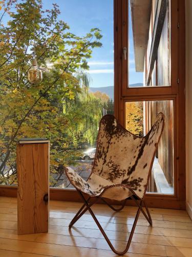 a chair sitting in front of a window at Tierra de Biescas in Biescas