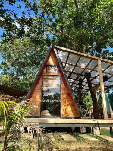 a small tree house with a sign on it at Isla Del Antoño in Cavinti