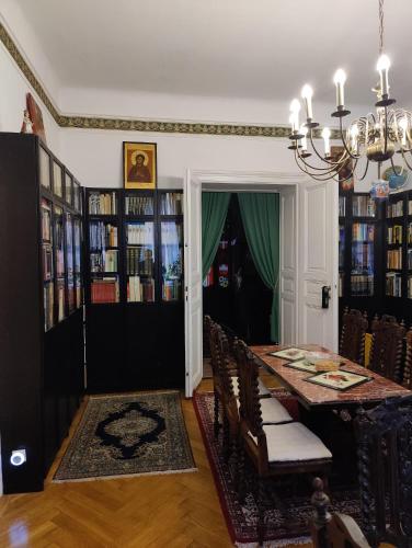 a dining room with a table and chairs and a chandelier at Luxury near Castle in Vienna