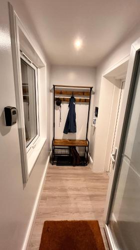 a hallway with a closet with a shirt hanging in it at Carnmhor, Isle of Skye - Stunning 242 year old cottage on its own sea shore! in Breakish
