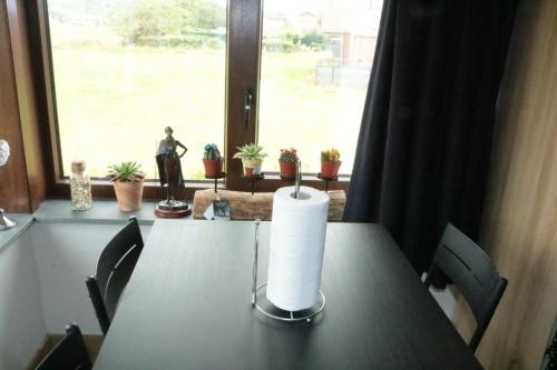 a candle on a table in front of a window at STUDIO TOUT CONFORT in Soignies