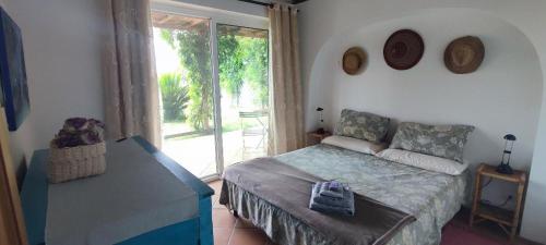 a bedroom with a bed and a sliding glass door at Villa Fonte Tartaruga Trevignano Romano in Trevignano Romano