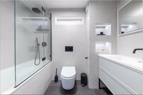 a bathroom with a toilet and a sink and a shower at Tanya's Place-Stylish flat in Marylebone in London