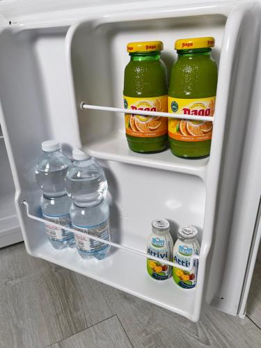 a refrigerator filled with lots of bottles of water at Camera in centro storico in Olbia