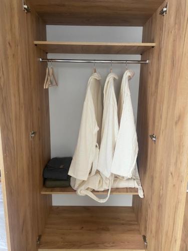 a closet with white towels hanging on a rack at Arevaham Boutique Hotel in Stepʼanavan