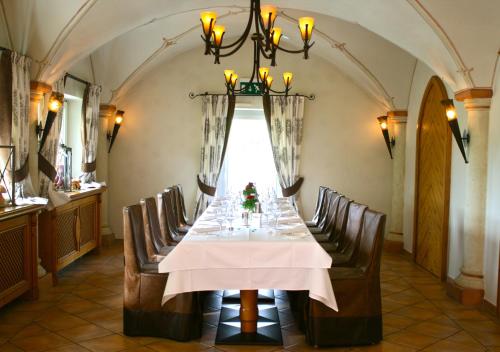 a dining room with a table with wine glasses at Hotel Landhaus Feckl in Böblingen