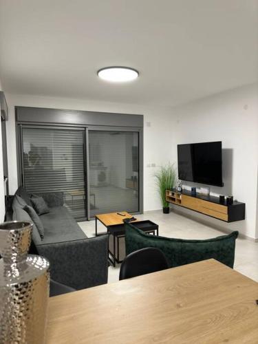 Μια τηλεόραση ή/και κέντρο ψυχαγωγίας στο Elegant 3 bedroom Ocean view Condo in Kiryat Yam