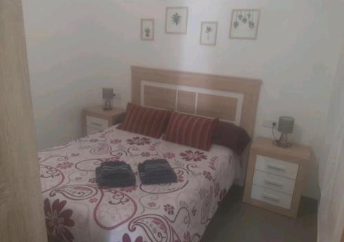 Un dormitorio con una cama con dos bolsas. en Bungalows en Santa pola, en Santa Pola