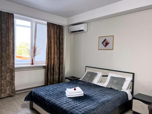 a bedroom with a bed with a tray on it at Lovely apartment with terrace in Chişinău